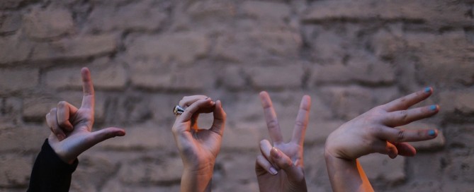 Picture of the word LOVE spelled out with fingers.