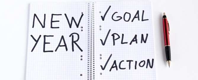 Picture of a journal with text that says New Year. Goal. Plan. Action.